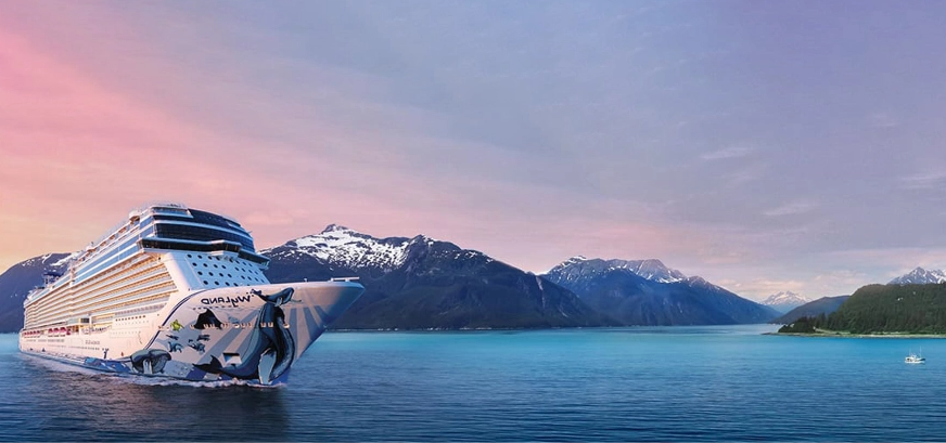 Cruise ship at scenic port with mountains